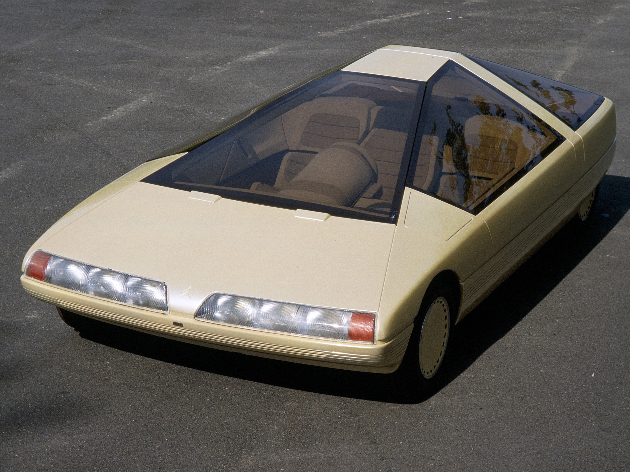 A three-quarter photo of the car, but it's beige now