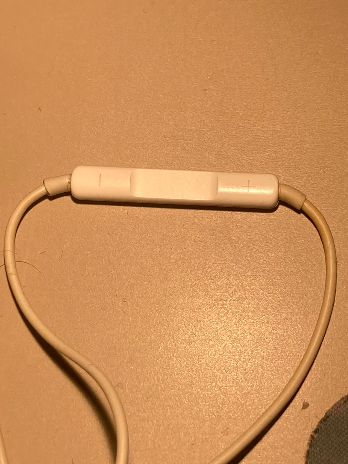 Picture of the buttons on old wired Apple earbuds