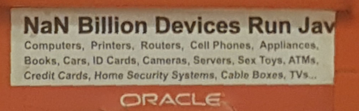 grainy photo of a sticker saying "NaN Billion Devices Run Jav"